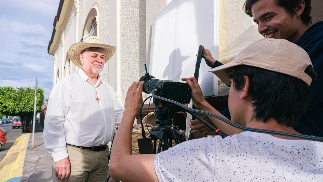 Photographer interviewing an elderly local resident outdoors