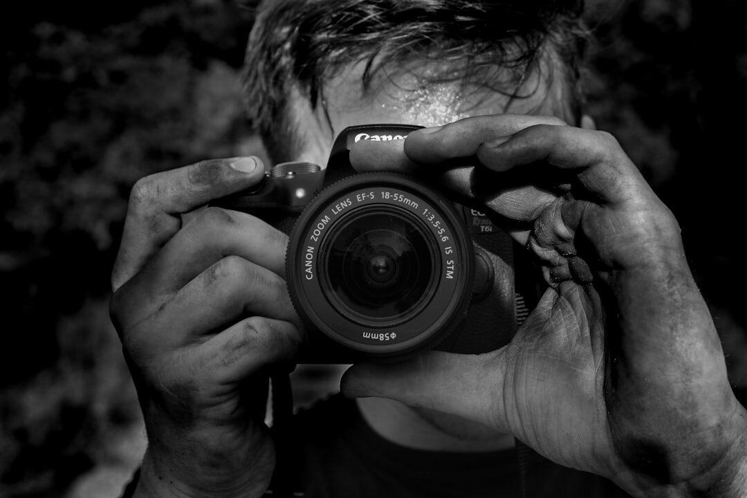 Danish male documentary photographer with camera around his neck