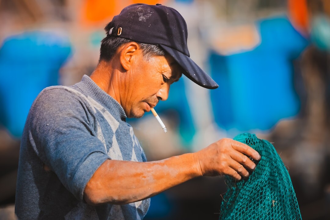 fisherman repairing nets